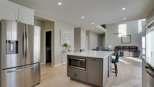 A modern kitchen with a stainless steel refrigerator, built-in microwave, and grey cabinetry. - Cozy Eden Prairie Home < 21 Mi to Twin Cities (Eden Prairie)