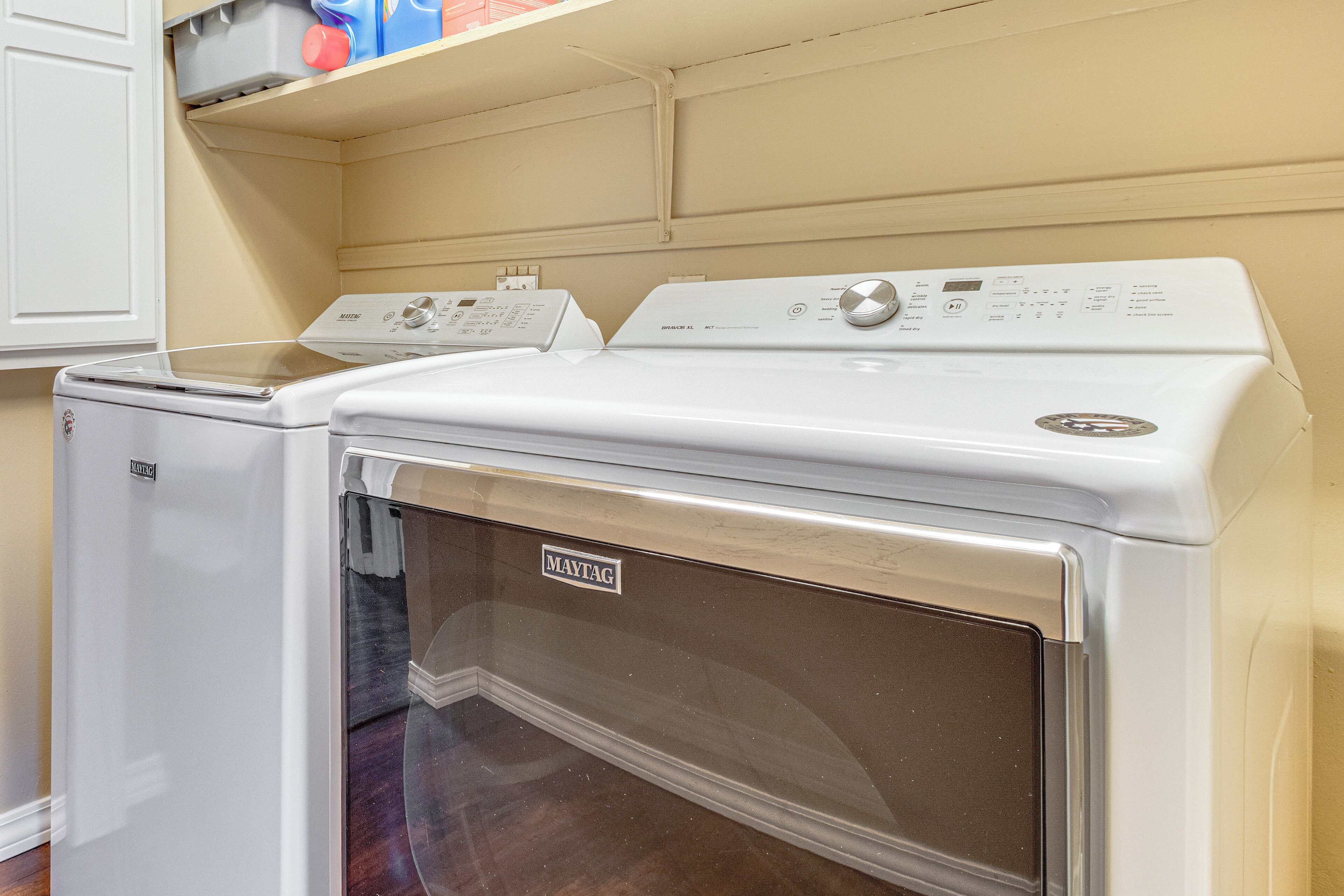 A laundry room with two Maytag washers and dryers.