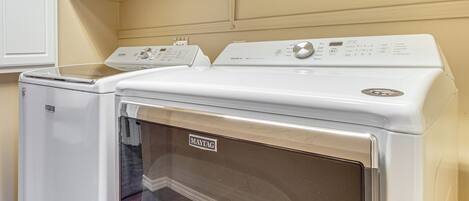 A laundry room with two Maytag washers and dryers.