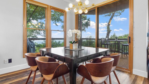 A dining area with a large table, six chairs, and a chandelier. - Hiking On-site: Mtn-view Burnsville Condo! (Burnsville)