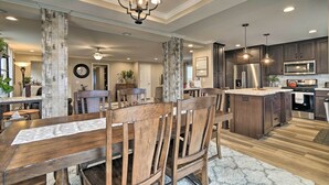 A modern kitchen with dark wood cabinets, stainless steel appliances, and a central island. - Lakefront Home w/ Deck, Fishing Dock & Canoe! (Bridgeport)