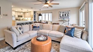 A modern living room with a sectional sofa, a coffee table, and a dining area in the background. - Waterfront Horseshoe Bay Retreat w/ Game Room! (Horseshoe Bay)