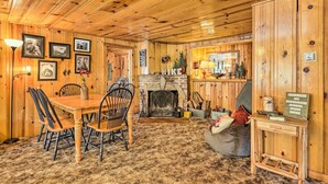 A wooden interior with a fireplace, dining table, and chairs. - California Retreat w/ Deck, Fire Pit & Grill! (Long Barn)