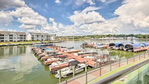 A marina with boats docked, a bridge in the background, and a row of buildings. - Lakeside Montgomery Condo Near Boat Rental! (Montgomery)