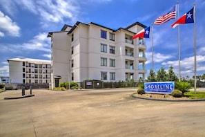 A modern multi-story building with a sign reading "Shoreline Condominiums." - Lakeside Montgomery Condo Near Boat Rental! (Montgomery)