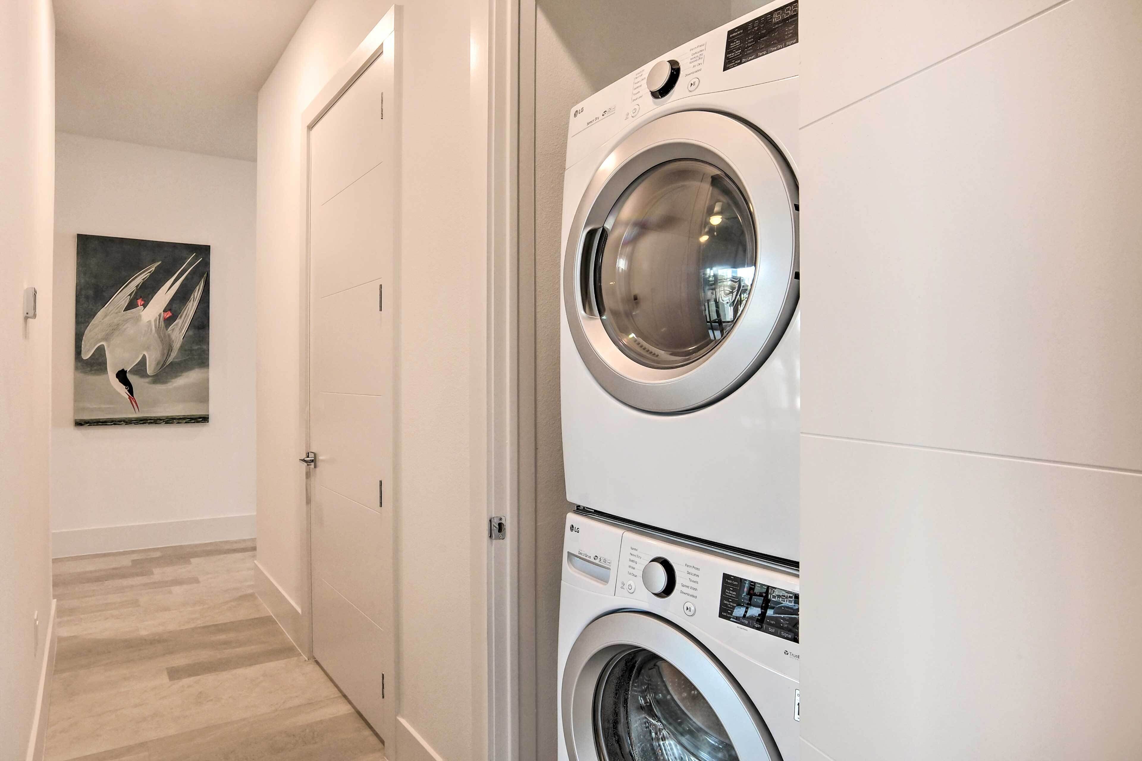 A laundry room with two stacked front-loading washing machines.