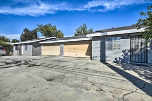 A two-story house with a garage, a driveway, and a tree providing shade. - Whittier Duplex Unit Near Beaches & Hiking! (Whittier)