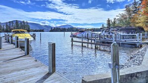 A dock with boats, a wooden pier, and a mountain in the background. - Lake George Getaway w/ Mountain + Water Views (Bolton Landing)