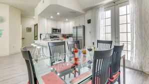 A modern kitchen with white cabinets, a microwave, and a refrigerator. - Clearwater Beach Hideaway: Walkable Location! (Clearwater Beach)