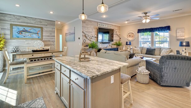 A spacious living area with a large island, a dining table, and a comfortable seating arrangement. - Resort Home ~ 1 Mi to Myrtle Beach Access! (Murrells Inlet)