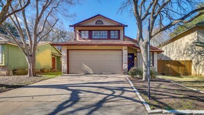 A two-story house with a garage, a front yard, and a tree. - Austin Vacation Rental w/ Yard ~ 14 Mi to Downtown (Austin)