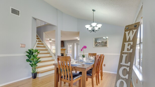 A dining area with a wooden table, chairs, and a 'WELCOME' sign. - Austin Vacation Rental w/ Yard ~ 14 Mi to Downtown (Austin)