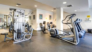 A gym with various exercise equipment, including a treadmill, elliptical, and weight machines. - Beautiful Branson Condo w/ Golf + Pool Access! (Branson)