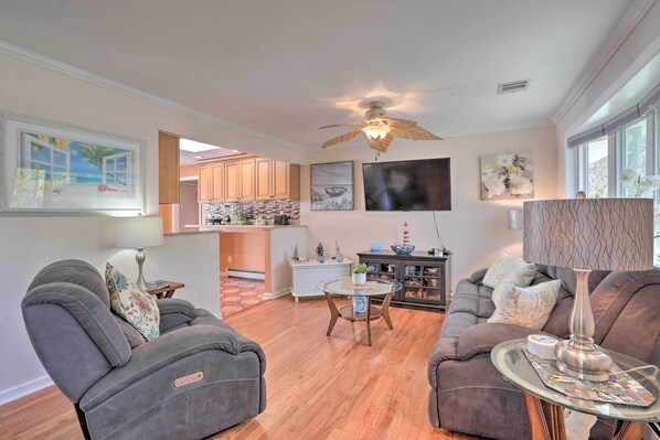 A spacious living room with a sofa, armchairs, a coffee table, and a ceiling fan. - Inviting Home w/ Inground Pool: 3 Mi to Beach (Brick)