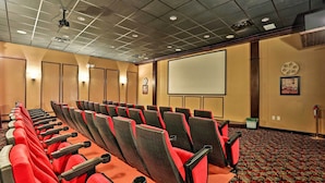 A conference room with rows of chairs, a projector, and a screen. - Grou-friendly Kissimmee Home: 7 Mi to Disney Parks (Kissimmee)