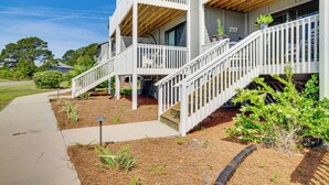 A multi-story building with white railings and a wooden deck. - Harbor Island Condo w/ Pool Access: Walk to Beach! (Harbor Island)