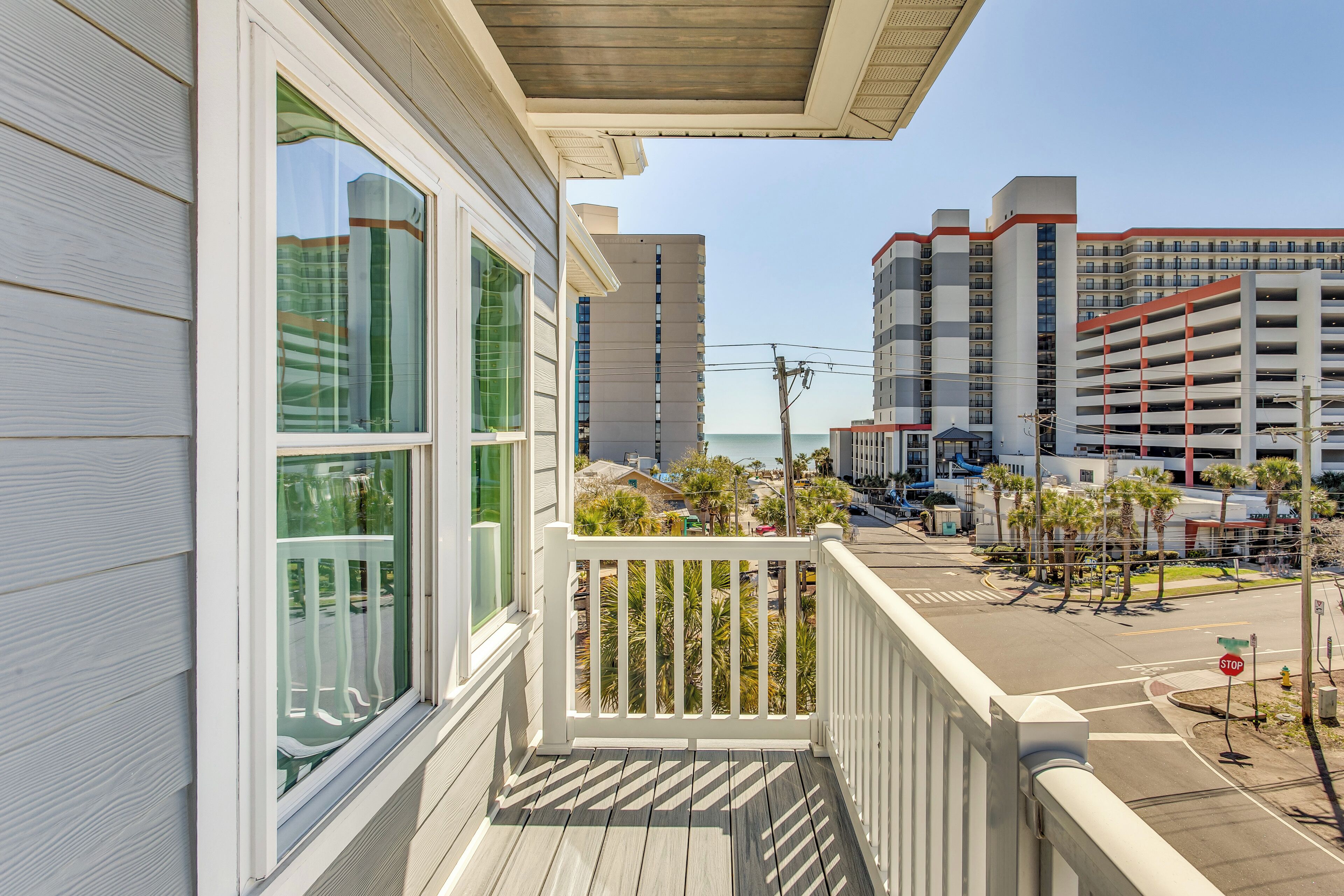 A balcony with a view of a city street and buildings.