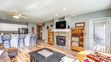 Apartment (2 Bedrooms) | Living area | Fireplace, video game console