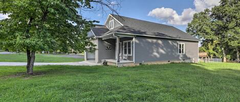 A single-story house with a front porch, a small attached garage, and a well-maintained lawn.