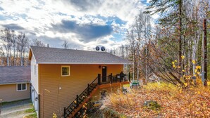 A two-story house with a front porch, a staircase, and a garage. - Convenient Fairbanks Guest Suite w/ Grill! (Fairbanks)