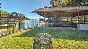 A covered outdoor seating area with a view of a lake and boats. - Lakefront Family Home, Recently Renovated! (Trinidad)