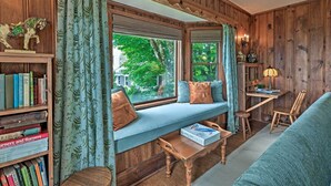 A cozy room with a built-in bench, a wooden bookshelf, and a desk with a lamp. - Amazing Historic Home w/ Stunning Mountain Views! (Blowing Rock)