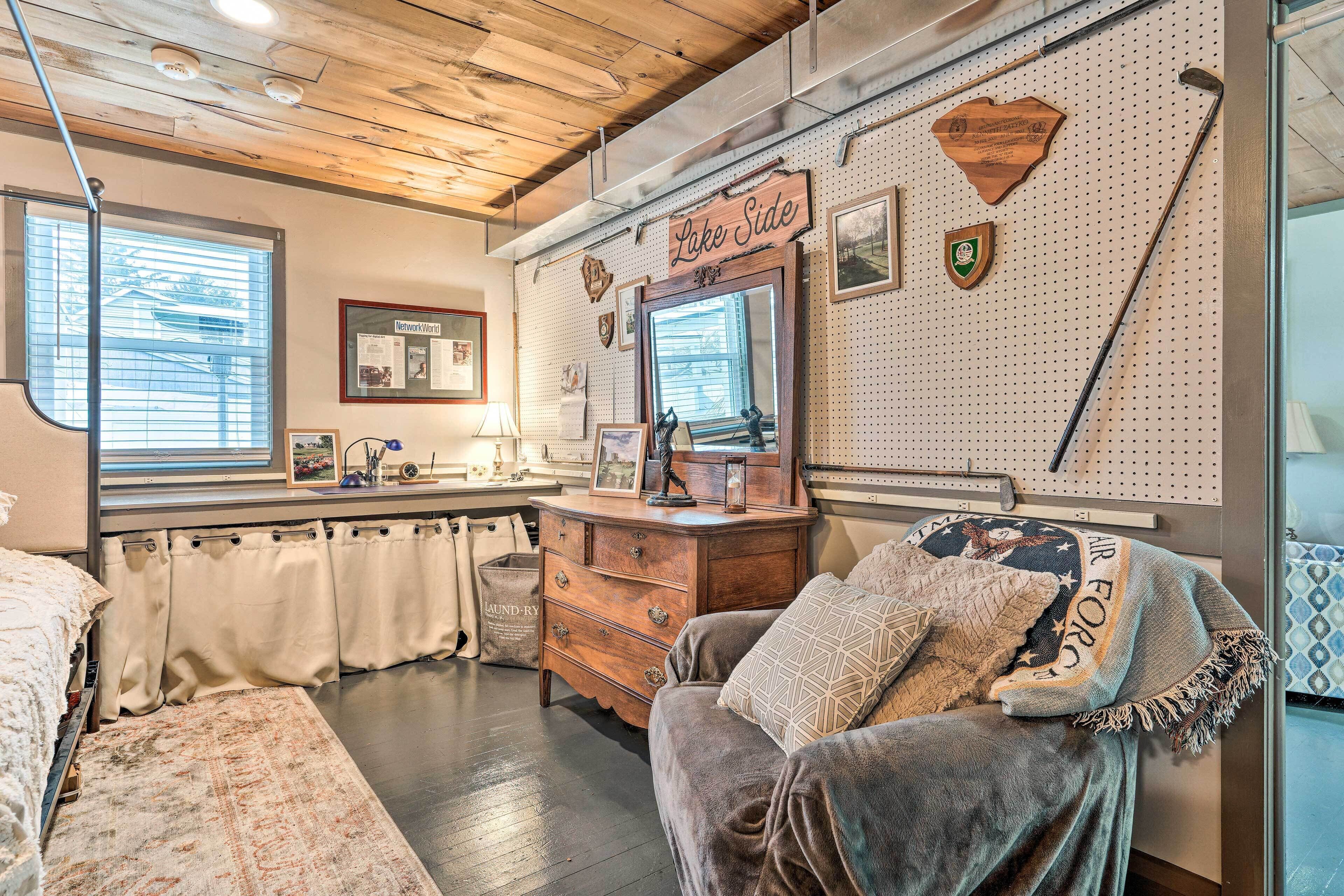A cozy room with a wooden dresser, a large mirror, and a sign reading "Lake Side."