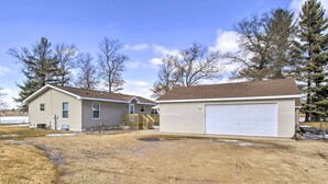 A two-story house with a garage and a covered driveway. - Waterfront Friendship Home w/ Private Pier! (Friendship)