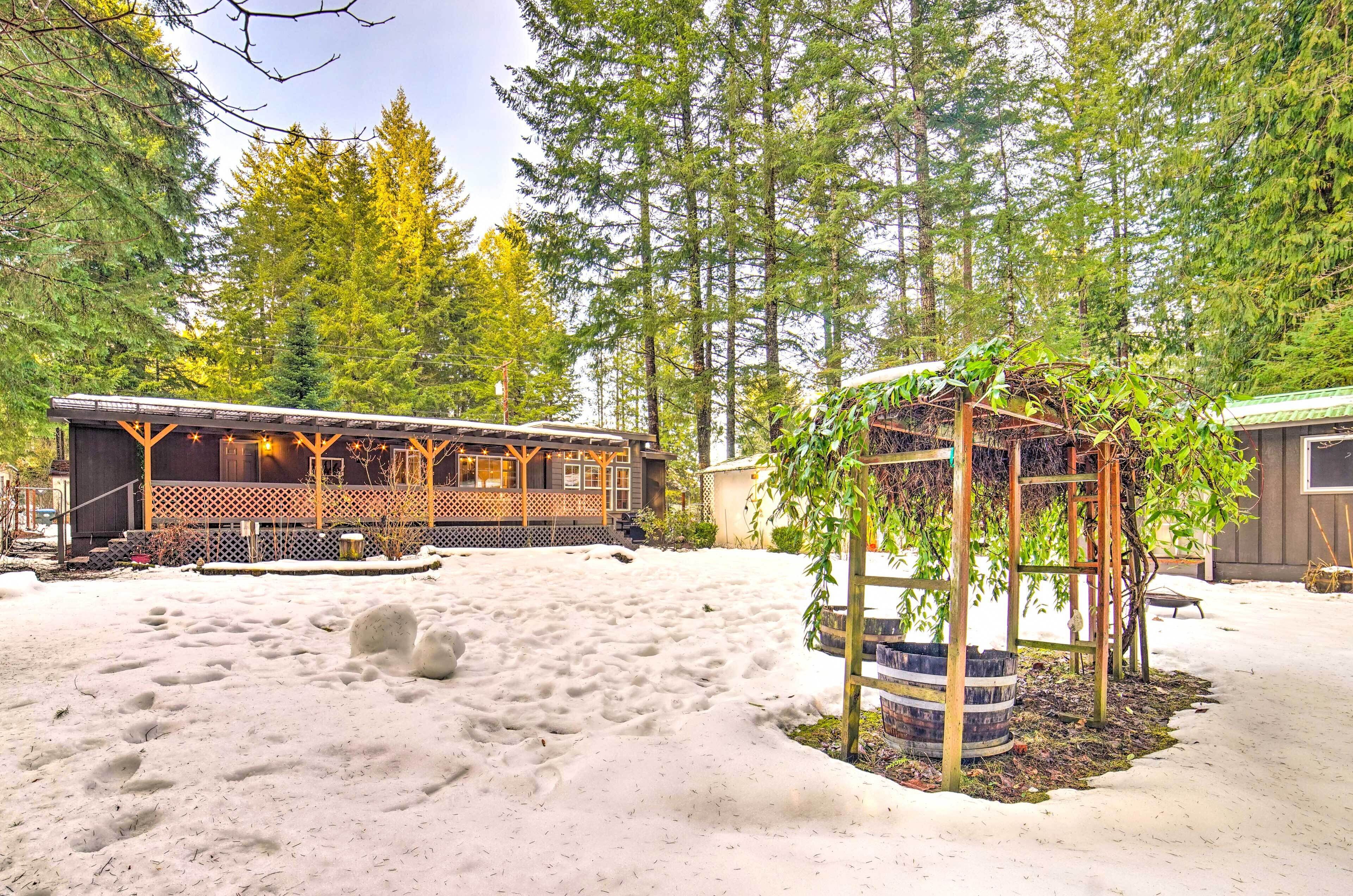A rustic cabin with a wooden deck and a small garden area.
