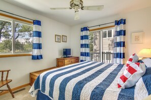 A bedroom with a bed, a desk, a chair, a ceiling fan, and a window with curtains. - Walk to Shore & Boardwalk: Bethany Beach Getaway! (Bethany Beach)