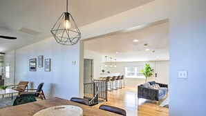 A spacious living area with a wooden dining table, a modern pendant light, and a comfortable seating arrangement. - Anglers Paradise, 1 Mi to Broyles Recreation Area (Townville)