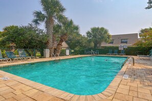 A swimming pool with clear blue water, surrounded by lounge chairs and palm trees. - Palmetto Dunes Villa w/ Deck & Lagoon Views! (Hilton Head Island)