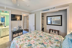 A bedroom with a bed, a dresser, a mirror, and a television. - Palmetto Dunes Villa w/ Deck & Lagoon Views! (Hilton Head Island)