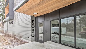 A modern building with a large glass entrance, a wooden ceiling, and a sign that reads "SOBO". - Chic Bozeman Apartment - 1 Block Off West Main St! (Bozeman)