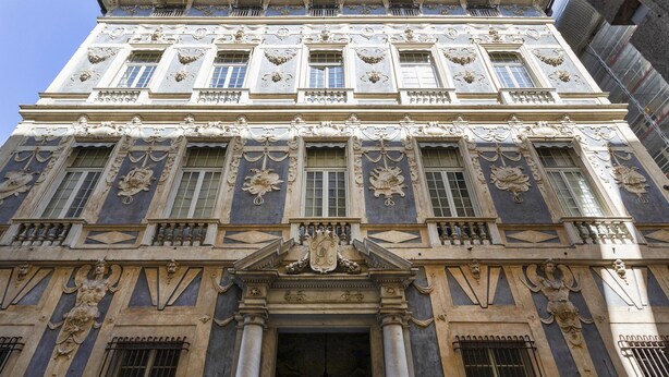 A historic building with ornate architectural details, including columns, decorative moldings, and statues. - Garibaldi Attic by Wonderful Italy (Genoa)