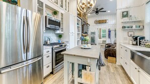A modern kitchen with stainless steel appliances, wooden cabinets, and a central island. - Highlands Vacation Rental - Walk to Main St! (Highlands)