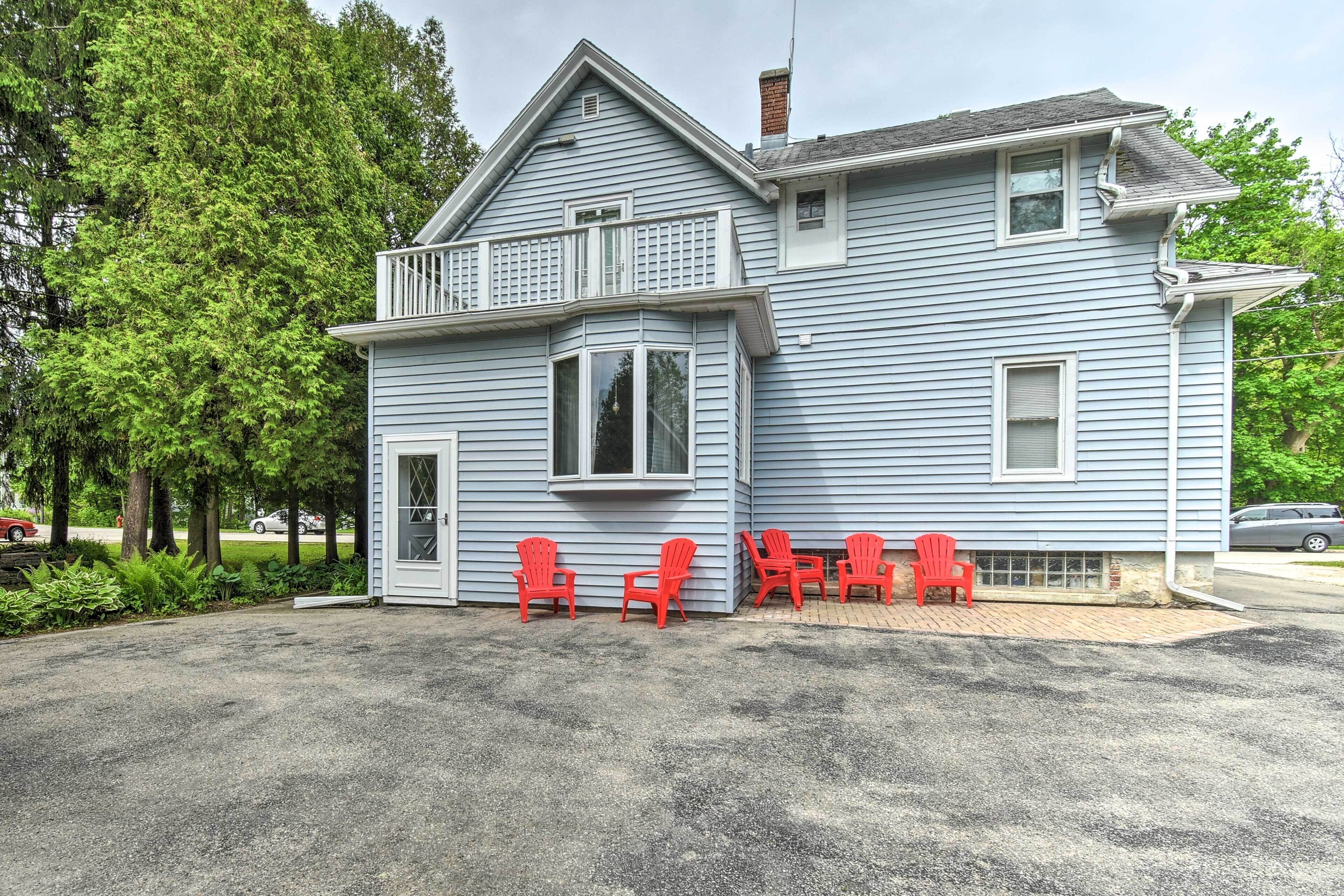 A two-story house with a balcony, a garage, and a driveway.