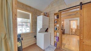 A compact laundry room with a washing machine, a drying rack, and a small window. - Palmyra Cottage w/ Deck on Whites Pond! (Palmyra)