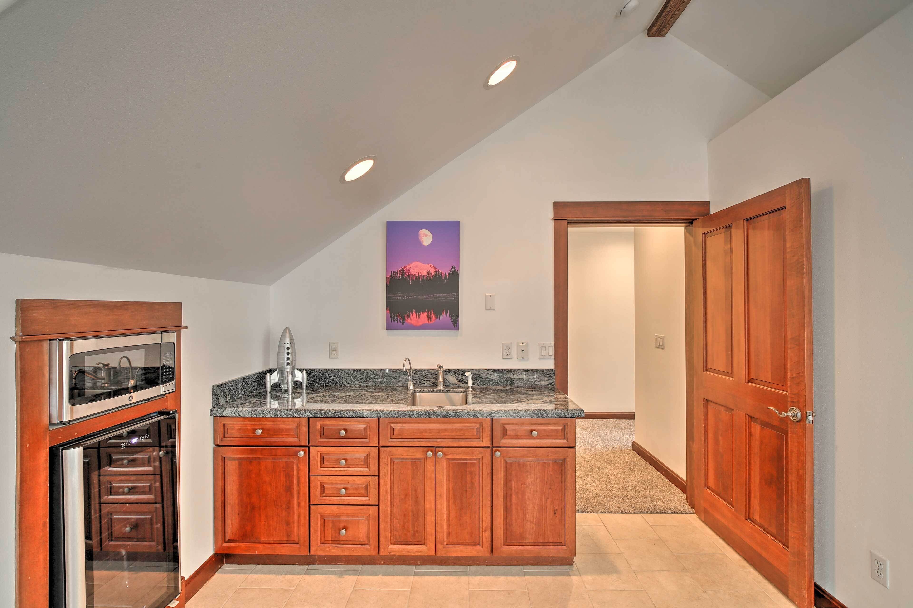 A kitchen with wooden cabinets, a built-in oven, and a granite countertop.