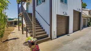 A two-story building with a front porch, a staircase, and a garage. - Logan Area Home Near Willard Bay State Park! (Brigham City)