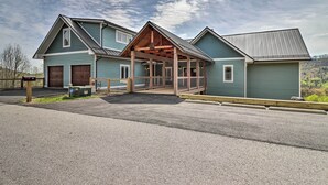 A two-story house with a covered porch and a garage. - Mountain Refuge w/ View, 12 Mi to Asheville! (Candler)