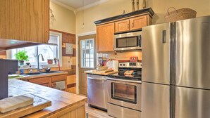 A modern kitchen with stainless steel appliances, wooden cabinets, and a large island. - Spacious Victorian Home 1/4 Mi to Holiday Valley! (Ellicottville)