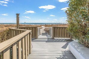 A wooden pathway leading to a gated entrance with a view of the beach and ocean. - Beachfront North Myrtle Beach Condo w/ Pool Access (North Myrtle Beach)