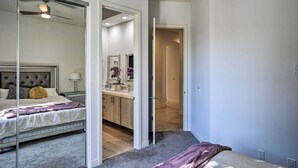 Une chambre à coucher avec un lit, une table de chevet, une commode et un miroir.