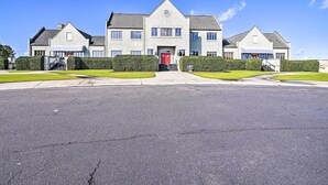 A large, modern building with a symmetrical facade, multiple windows, and a central entrance. - Golfers Paradise in Myrtle Beach w/ Balcony! (Myrtle Beach)