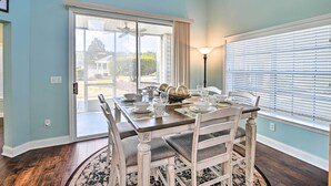 A dining area with a table set for four, a ceiling fan, and a view through a glass door to the outside. - Golfers Paradise in Myrtle Beach w/ Balcony! (Myrtle Beach)