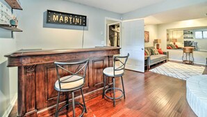 A bar area with two stools, a wooden bar counter, and a sign that reads "MARTINI". - Pittsburgh Retreat w/ Deck ~ 4 Mi to Dtwn! (Pittsburgh)