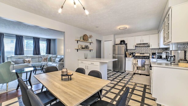 A modern kitchen with white cabinets, a stainless steel refrigerator, and a coffee maker. - Pittsburgh Retreat w/ Deck ~ 4 Mi to Dtwn! (Pittsburgh)