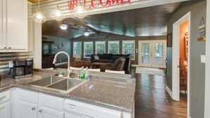 A modern kitchen with granite countertops, a built-in sink, and a coffee maker. - Ferriday Lakehouse w/ Private Dock, Deck, & Yard! (Ferriday)