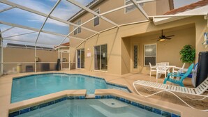 An indoor swimming pool with a clear ceiling, a ceiling fan, and a seating area with chairs and a table. - Pool & Lanai: Davenport Home 12 Mi to Disney (Davenport)